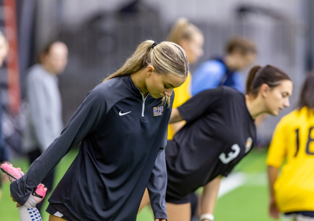 Ava Boyd, a Pitt soccer player and member of the Riveters' inaugural 2025 team, stretches before the Riveters' open combine last December at the AHN Montour Sports Complex. (Photo: Mallory Neil/Riveters SC)