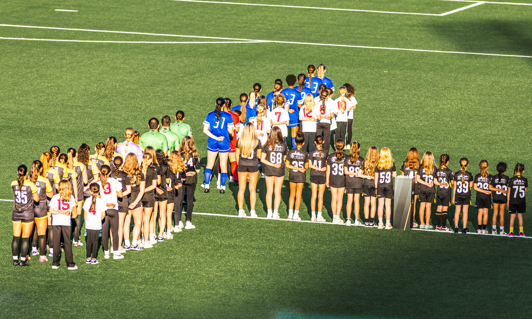 Players from the Pittsburgh Riveters and Cleveland Force are joined on the field by players from the Riverhounds Academy before the teams' USL W League opener on May 16, 2025 at Highmark Stadium. (Photo Ryan Shaffer/Riveters SC)