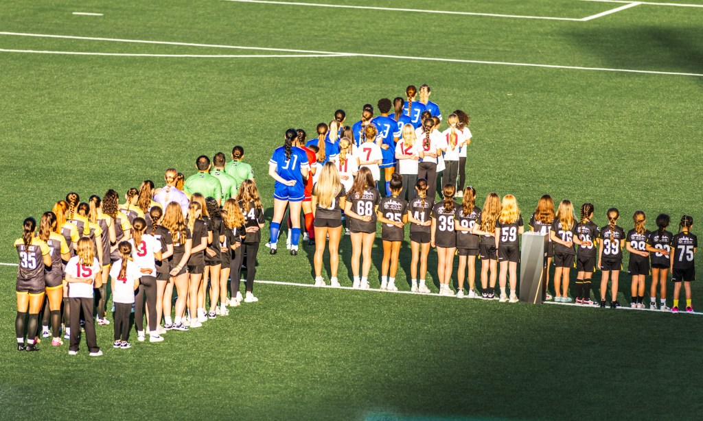 Players from the Pittsburgh Riveters and Cleveland Force are joined on the field by players from the Riverhounds Academy before the teams' USL W League opener on May 16, 2025 at Highmark Stadium. (Photo Ryan Shaffer/Riveters SC)