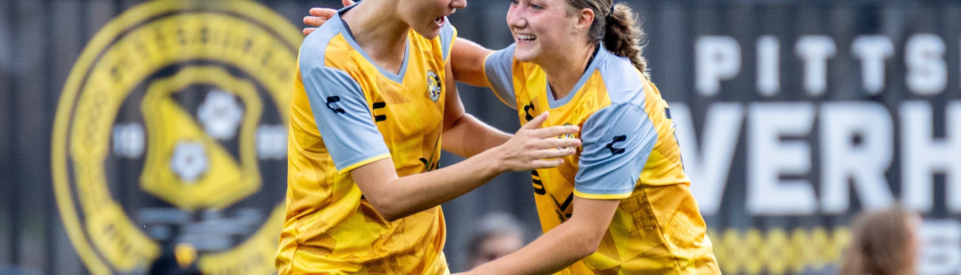 Pittsburgh Riveters players Tanum Nelson (left) and Anna Korney celebrate after Nelson scored in the team's 7-0 win over Erie Sports Center on June 15, 2025 at Highmark Stadium in Pittsburgh. (Photo: Chris Cowger/Riveters SC)