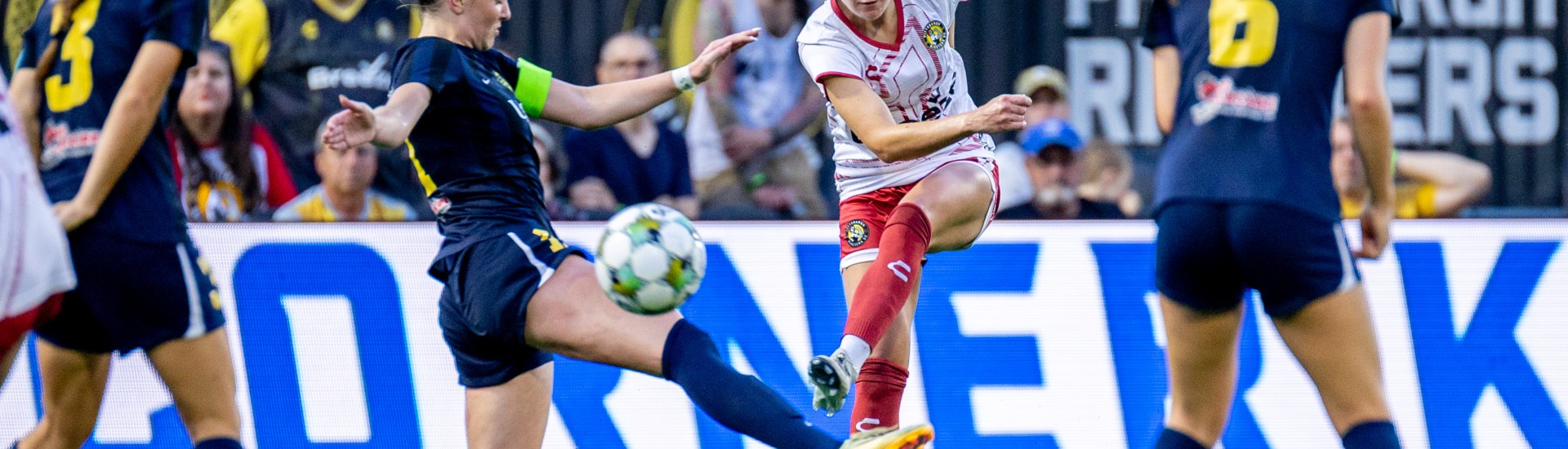 Pittsburgh Riveters defender Abi Hugh strikes a shot through defenders in the team's 2-1 win over Steel City FC on June 27, 2025 at Highmark Stadium in Pittsburgh. (Photo: Chris Cowger/Riveters SC)