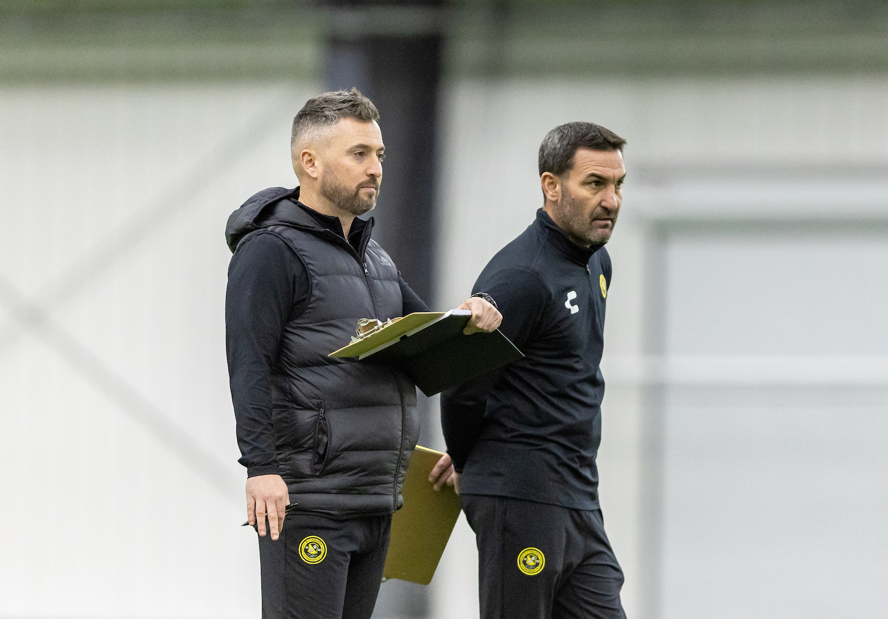Pittsburgh Riveters SC head coach Scott Gibson (left) and assistant coach John Rotz watch during the team's inaugural Open Tryout on Dec. 6, 2024 at AHN Montour Sports Complex in Coraopolis, Pa. (Photo: Mallory Neil/Riveters SC)