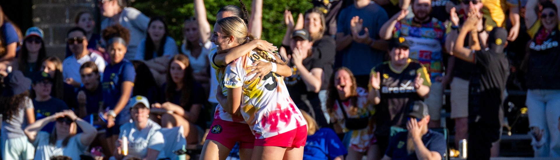 Anna Korney receives a hug in front of traveling Pittsburgh Riveters supporters after scoring in the team's 2-0 win over Steel City FC on May 28, 2026 at Founders Field in Indiana Township, Pa. (Photo: Chris Cowger/Riveters SC)