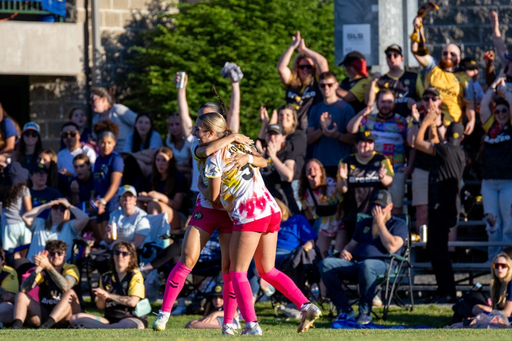 Anna Korney receives a hug in front of traveling Pittsburgh Riveters supporters after scoring in the team's 2-0 win over Steel City FC on May 28, 2026 at Founders Field in Indiana Township, Pa. (Photo: Chris Cowger/Riveters SC)