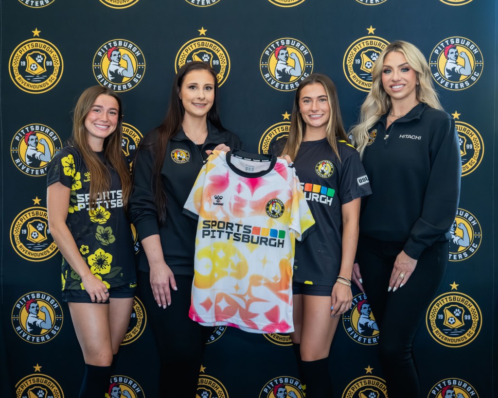 Celebrating the announcement of the new partnership between Hitachi Energy and the Pittsburgh Riveters are, from left: Riveters defender Bella Vozar; Hitachi Energy HR Business Partner DTB Americas, Allie Anzelone; Riveters forward Lucia Wells; and Hitachi Energy Executive Assistant High Voltage Americas, Sarah Fricchione.