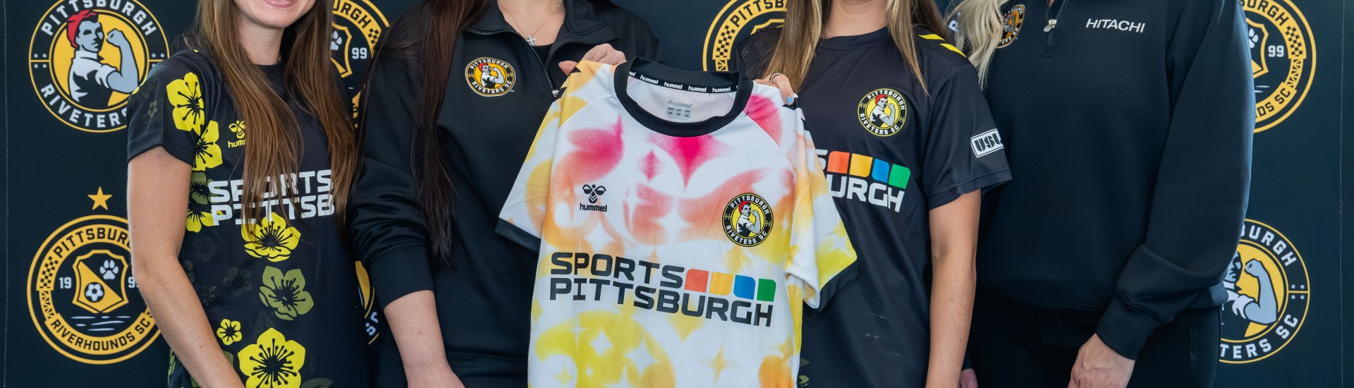 Celebrating the announcement of the new partnership between Hitachi Energy and the Pittsburgh Riveters are, from left: Riveters defender Bella Vozar; Hitachi Energy HR Business Partner DTB Americas, Allie Anzelone; Riveters forward Lucia Wells; and Hitachi Energy Executive Assistant High Voltage Americas, Sarah Fricchione.