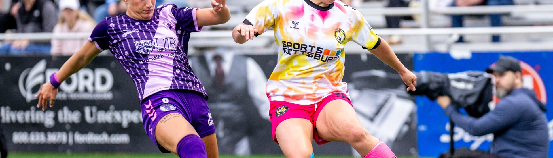 Pittsburgh Riveters midfielder Ellen Molloy evades the pressure from Flower City 1872 midfielder Mia Gray in the teams' match May 23, 2026 at F.N.B. Stadium in Pittsburgh. (Photo: Chris Cowger/Riveters SC)