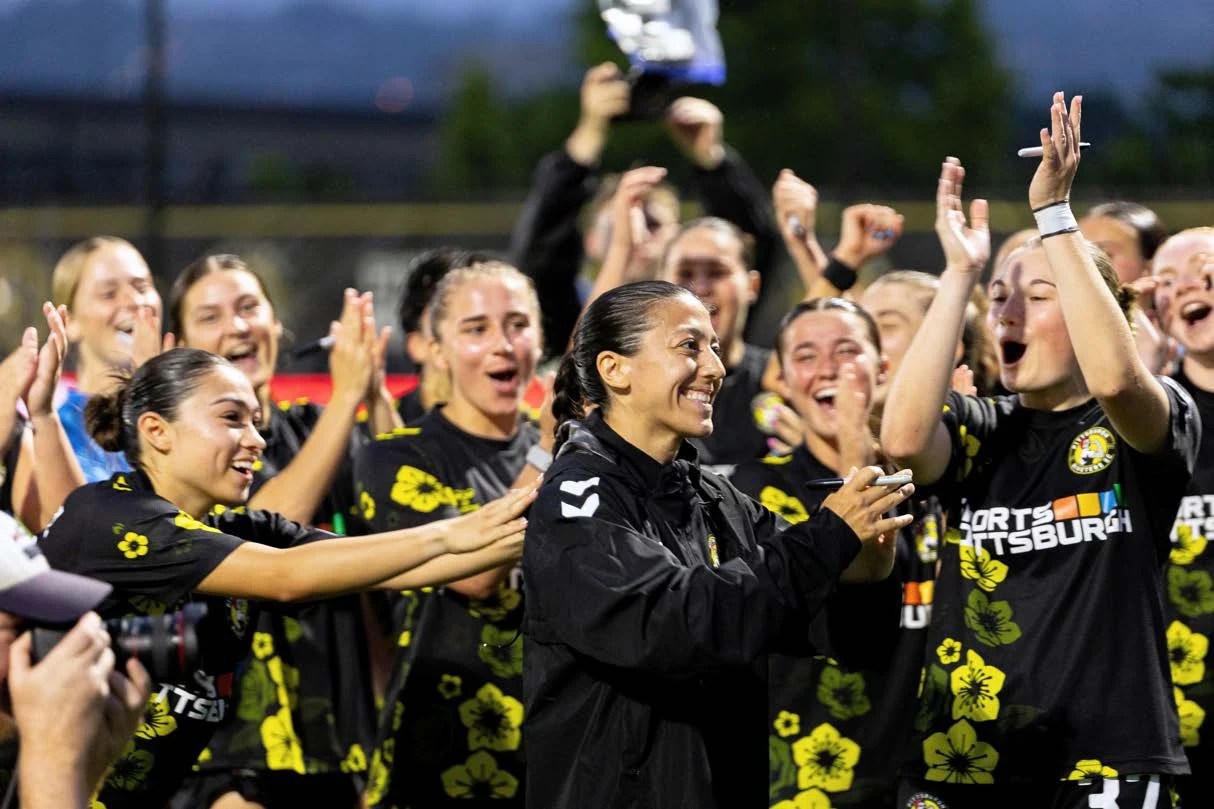 Pittsburgh Riveters players celebrate together on the field